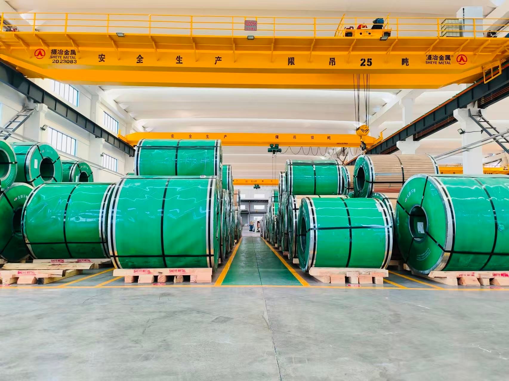 Stainless steel coils on wooden pallets in the Sheye Metal raw material warehouse