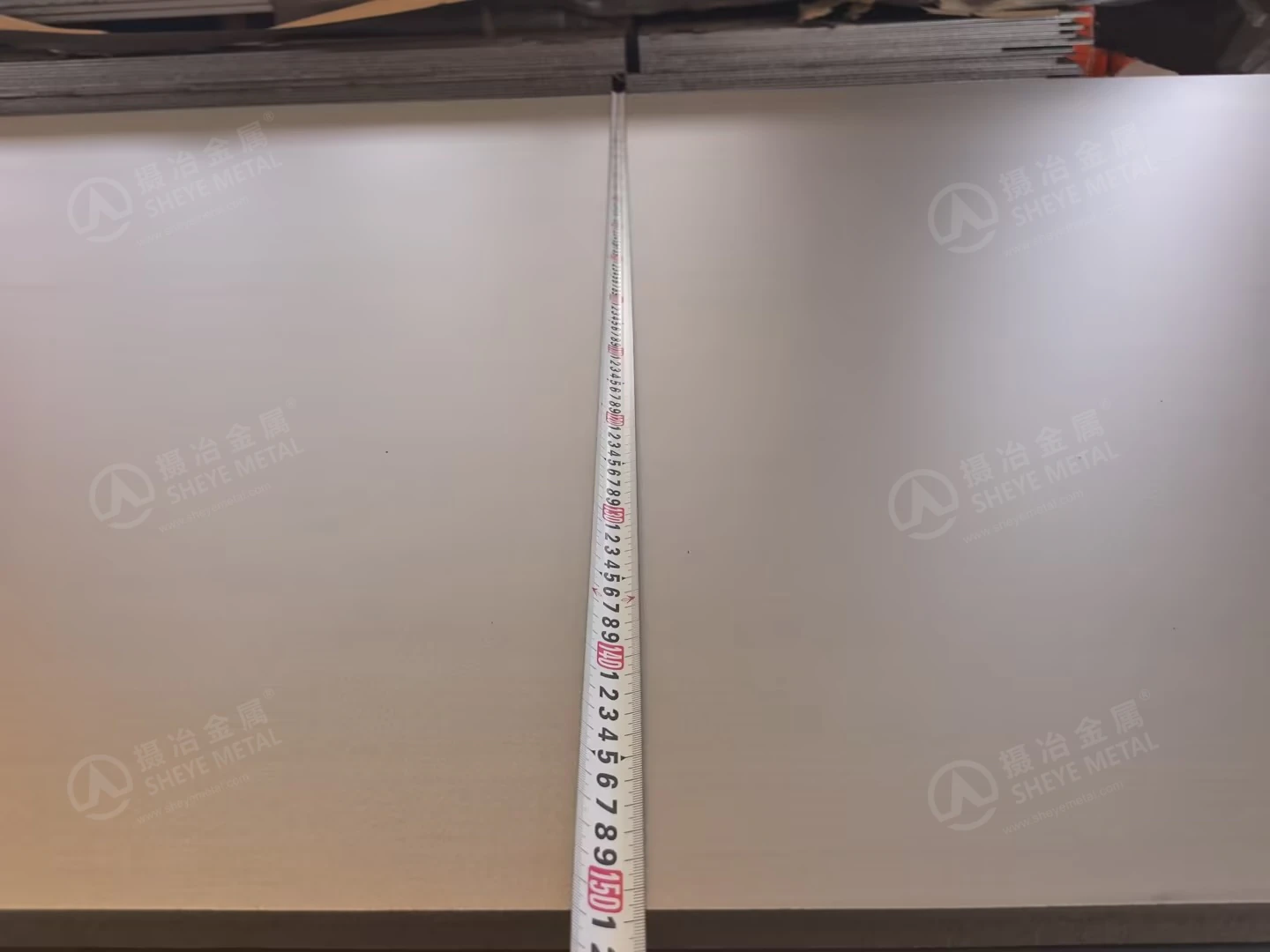 A measuring tape extended across the width of a 2507 stainless steel plate.