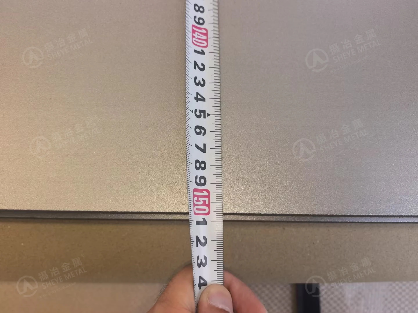 Close-up of the measuring tape at the edge of a nominal 1500 mm wide stainless steel plate.