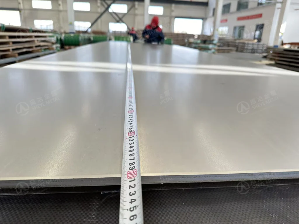 Sheye Metal checking the length of a nominal 12 × 1500 × 6000 mm 310S hot rolled plate for export to Vietnam.